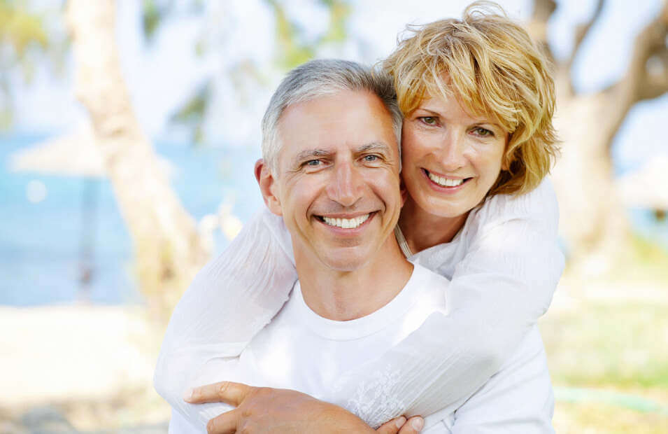 couple smiling after receiving dental veneers