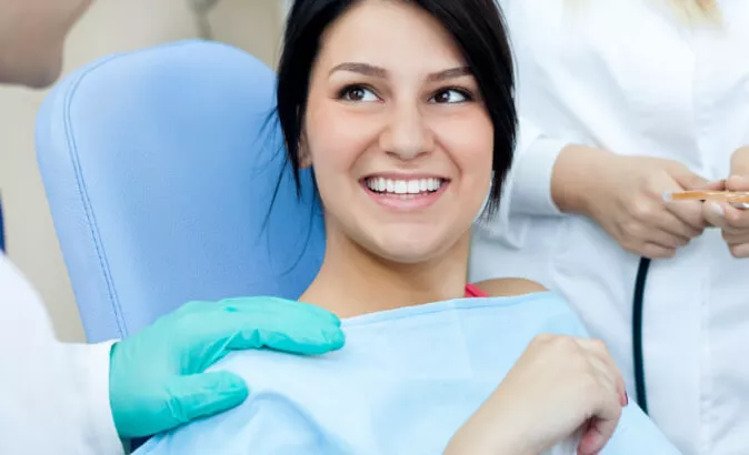 smiling patient sitting in dental chair
